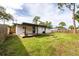 Home features a large backyard with a covered patio at 603 Conrad Dr, New Smyrna Beach, FL 32168