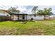 Home features a backyard with a covered patio and firepit at 603 Conrad Dr, New Smyrna Beach, FL 32168