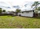 View of home's back and spacious grassy yard at 603 Conrad Dr, New Smyrna Beach, FL 32168
