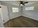 Well-lit bedroom with wood-look floors and ceiling fan at 603 Conrad Dr, New Smyrna Beach, FL 32168