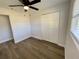 Well-lit bedroom with wood-look floors and a large closet at 603 Conrad Dr, New Smyrna Beach, FL 32168