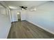 Bedroom with gray vinyl flooring, window, and ceiling fan at 603 Conrad Dr, New Smyrna Beach, FL 32168