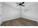 Bright bedroom with wood-look floors and ceiling fan at 603 Conrad Dr, New Smyrna Beach, FL 32168