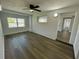 Bright bedroom with gray vinyl flooring, ceiling fan, and window at 603 Conrad Dr, New Smyrna Beach, FL 32168