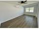 Bedroom with gray vinyl flooring, window, and ceiling fan at 603 Conrad Dr, New Smyrna Beach, FL 32168
