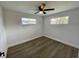 Spacious bedroom with wood-look floors and two windows at 603 Conrad Dr, New Smyrna Beach, FL 32168