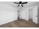 Spacious bedroom with wood-look floors and access to bathroom at 603 Conrad Dr, New Smyrna Beach, FL 32168