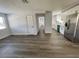 Bright hallway with gray vinyl flooring and access to kitchen and rooms at 603 Conrad Dr, New Smyrna Beach, FL 32168