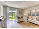 Living room with sliding glass doors leading to a backyard view at 7103 Carib Grackle Dr, Saint Cloud, FL 34773