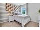 Charming bedroom with twin-size bed and geometric wall art at 7140 Painted Bunting Way, St Cloud, FL 34773