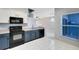 Modern kitchen with blue cabinets, black appliances, and white countertops at 14053 Wild Majestic St, Orlando, FL 32828