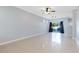 Spacious living room with tile floors, ceiling fan, and access to backyard at 14053 Wild Majestic St, Orlando, FL 32828