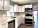 Modern kitchen with white cabinets, stainless steel appliances, and quartz countertops at 1416 34Th St, Orlando, FL 32839