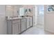 Double vanity bathroom with granite countertop and access to a private balcony at 4807 Khloe Ct, Winter Haven, FL 33884