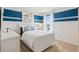 Cozy bedroom with a white bed frame and nautical-themed decor at 4807 Khloe Ct, Winter Haven, FL 33884
