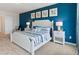 Main bedroom with blue accent wall and king-size bed at 4807 Khloe Ct, Winter Haven, FL 33884