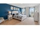 Main bedroom with blue accent wall and king-size bed at 4807 Khloe Ct, Winter Haven, FL 33884