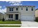 Two-story house with a white garage door and blue front door at 4807 Khloe Ct, Winter Haven, FL 33884