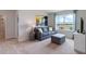 Relaxing sitting area with a comfortable couch and ottoman at 4807 Khloe Ct, Winter Haven, FL 33884