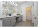 Modern bathroom with double vanity and grey cabinets at 6240 Sand Skipper Rd, Orlando, FL 32821