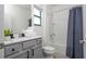 Clean bathroom with a tub, shower, and gray vanity at 6240 Sand Skipper Rd, Orlando, FL 32821