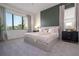 Main bedroom with large bed, green accent wall, and ample natural light at 6240 Sand Skipper Rd, Orlando, FL 32821