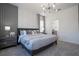 Main bedroom with gray upholstered bed and marble accent wall at 6240 Sand Skipper Rd, Orlando, FL 32821