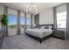 Main bedroom with gray upholstered bed and marble accent wall at 6240 Sand Skipper Rd, Orlando, FL 32821