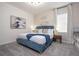 Spacious bedroom with a teal upholstered bed and built-in shelves at 6240 Sand Skipper Rd, Orlando, FL 32821