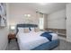 Spacious bedroom with a teal upholstered bed and built-in shelves at 6240 Sand Skipper Rd, Orlando, FL 32821