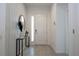 Bright entryway with tiled floor, console table, and mirror at 6240 Sand Skipper Rd, Orlando, FL 32821