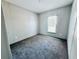 Bright bedroom featuring carpeted floor and window with blinds at 7020 Sw 156 Pl, Dunnellon, FL 34432
