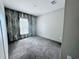 Bedroom with wood-like wall accent and grey carpet at 7020 Sw 156 Pl, Dunnellon, FL 34432