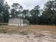 Tan mobile home exterior with surrounding trees at 7020 Sw 156 Pl, Dunnellon, FL 34432