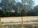 Wooded lot with a dirt road and wooden fence at 7020 Sw 156 Pl, Dunnellon, FL 34432