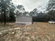 Tan manufactured home and yard with a vehicle at 7020 Sw 156 Pl, Dunnellon, FL 34432