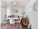 Dining area with a white table, chairs, and a guitar stand at 710 Spruce St, New Smyrna Beach, FL 32168
