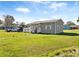 Tan house with a spacious yard and partial view of neighbors at 710 Spruce St, New Smyrna Beach, FL 32168