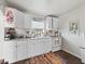 Charming kitchen with white cabinets and wood-look floors at 710 Spruce St, New Smyrna Beach, FL 32168