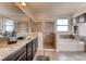 Elegant bathroom featuring double sinks, a soaking tub, and a walk-in shower at 1676 Three Bars Rd, Kissimmee, FL 34744