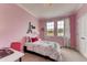 Charming bedroom with a full-size bed, pink walls, and Parisian decor at 1676 Three Bars Rd, Kissimmee, FL 34744