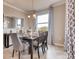 Elegant dining room with a large window and a modern chandelier at 1676 Three Bars Rd, Kissimmee, FL 34744