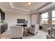 Relaxing sitting area with two armchairs, a coffee table, and built-in cabinets at 1676 Three Bars Rd, Kissimmee, FL 34744