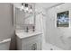 Modern bathroom with white vanity, marble tile, and updated fixtures at 27623 Lisa Dr, Tavares, FL 32778