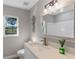 Clean bathroom with modern vanity and a large mirror at 27623 Lisa Dr, Tavares, FL 32778