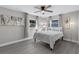 Comfortable bedroom with a queen-size bed, ceiling fan, and neutral decor at 27623 Lisa Dr, Tavares, FL 32778