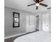 Bedroom with a full-size bed, ceiling fan, and large mirror at 27623 Lisa Dr, Tavares, FL 32778