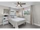 Bedroom with a queen bed, nightstand, and ceiling fan at 27623 Lisa Dr, Tavares, FL 32778