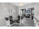 Small glass-top dining table with four chairs, offering a view of the living room at 27623 Lisa Dr, Tavares, FL 32778