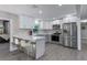 Modern kitchen with gray and white cabinets, stainless steel appliances and breakfast bar at 27623 Lisa Dr, Tavares, FL 32778